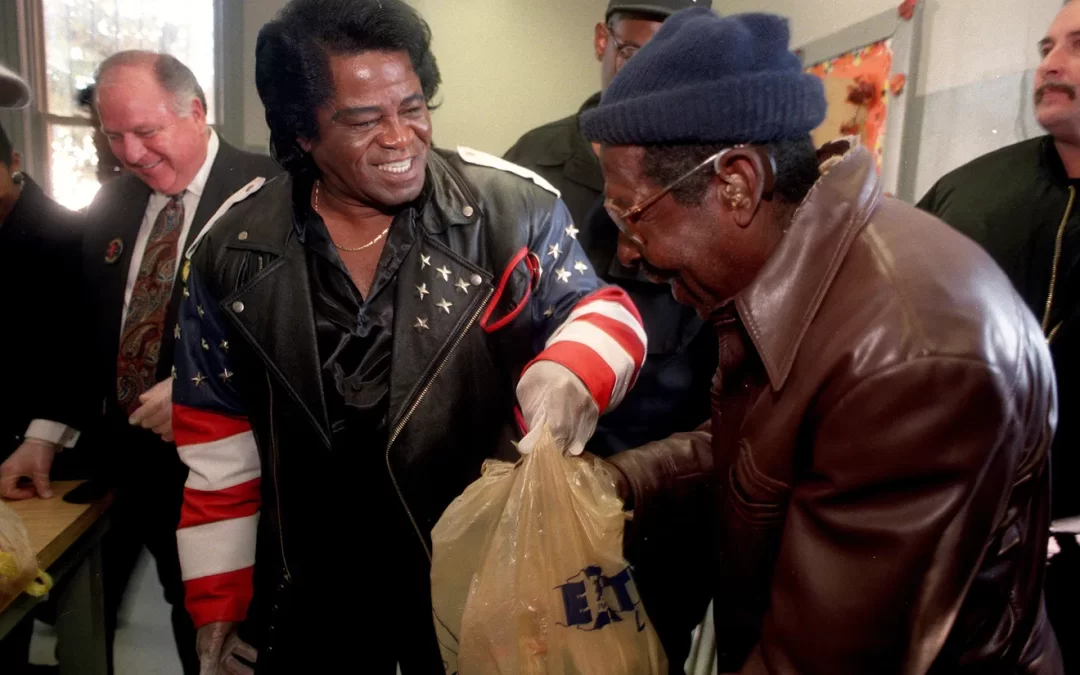 FILE - James Brown passes out turkeys at his fifth annual Turkey Giveaway at Dyess Park, in November 1997. The singer expected to hand out hundreds of the birds to help feed the city's needy for Thanksgiving. KATHY MOORE, THE AUGUSTA CHRONICLE